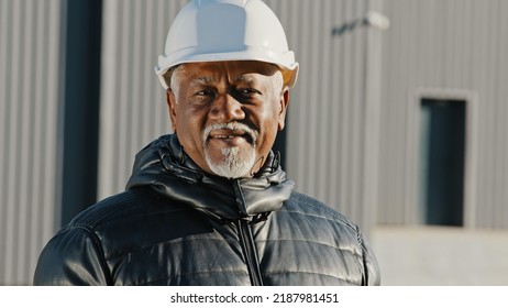 Portrait Of Elderly African American Confident Man Professional Engineer Construction Worker In Safety Helmet Successful Builder Contractor Foreman Standing Outdoors Site Close-up Looking At Camera