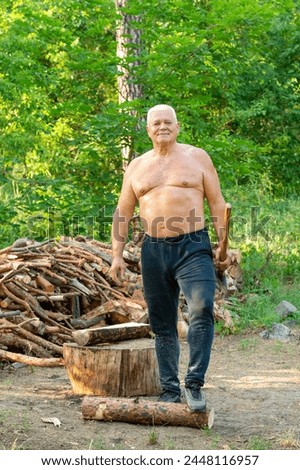portrait of an elderly man with an ax against a forest background