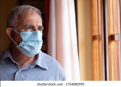 Portrait Of Elderly Man With Mask Inside His Home