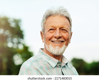 Portrait Of An Elderly Man Outdoors. Happy Senior Man In Park