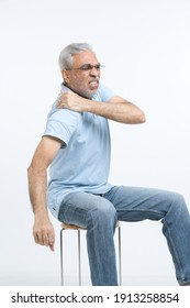 Portrait Of Elderly Man Suffering From Shoulder Pain