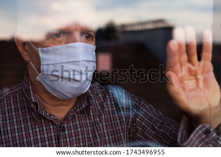 Portrait of elderly senior citizen wearing face mask looking through room window,Coronavirus COVID-19 pandemic outbreak nursing home crisis,high mortality rate and death cases among older population Stock photo © 
