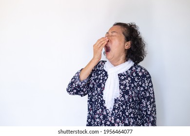 Portrait of an elderly woman feeling Sleepy and yawn - Powered by Shutterstock