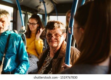 Portrait of an elderly woman with glasses riding public transport - Powered by Shutterstock