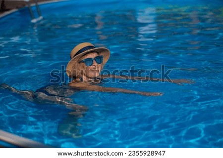 Similar – Ein Mann mit Sonnenhut und einer gelben Gummiente in einem Pool.