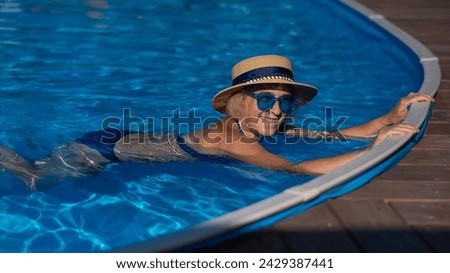 Similar – Ein Mann mit Sonnenhut und einer gelben Gummiente in einem Pool.