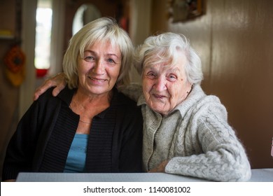 Portrait of an elderly woman with her adult daughter.
