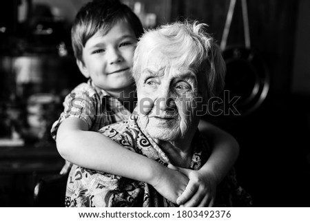 Similar – Grandma cuddles up with her grandson