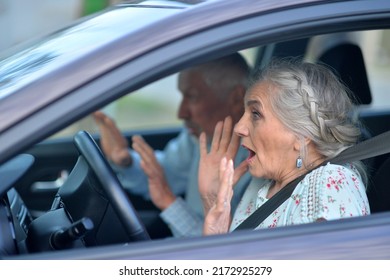 portrait of an elderly woman scared in the car
