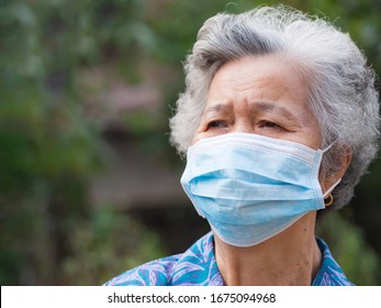 Portrait of elderly woman with short white hair, wearing face mask for health because have air pollution PM 2.5. Mask for protect virus, bacteria, pollen grains. Health care concept - Powered by Shutterstock