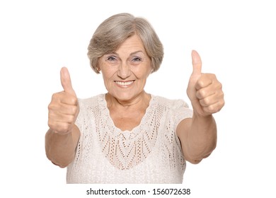 Portrait of elderly woman showing thumbs up on white background