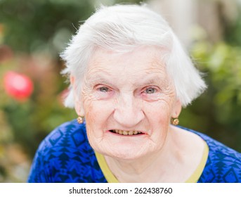 Portrait Of Elderly Woman Smiling At The Camera