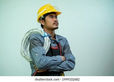 Portrait Of Electrician Contractor With Electric Cable At Isolated On White Background.