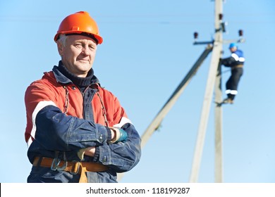 Portrait Of Electrician Lineman Repairman Worker On Electric Post Power Pole Line Work