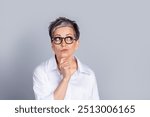 Portrait of elegant aged lady office worker look empty space ponder wear shirt isolated on grey color background