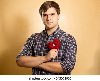 Portrait Of Elegant Man Holding Red Heart At Chest