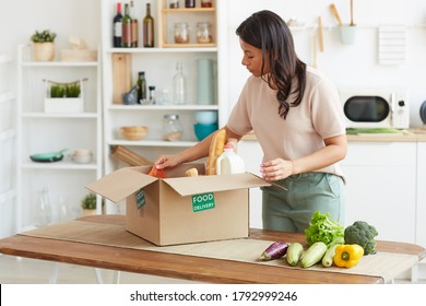 Portrait Of Elegant Mixed-race Woman Unpacking Box With Food While Enjoying Delivery From Farmers Market, Copy Space