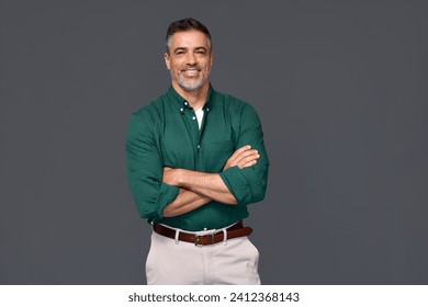 Portrait of elegant older business man, smiling middle aged mature businessman professional executive or lawyer wearing green shirt looking at camera standing arms crossed isolated on gray background. - Powered by Shutterstock