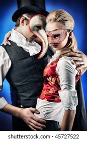 Portrait Of The Elegant Young Couple In Masquerade Costumes. Shot In A Studio.