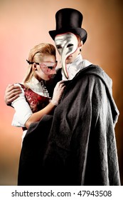 Portrait Of The Elegant Young Couple In Masquerade Costumes. Shot In A Studio.