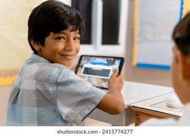 Portrait of Elementary Hispanic school Kids using tablet computers in class - Powered by Shutterstock