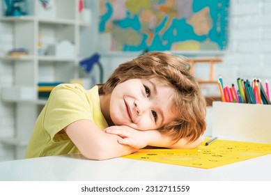 Portrait of elementary pupil looking at camera. Schoolkid or preschooler learn. Portrait of pupil of primary school study indoors. School dream. Daydreamer school child. Dreamy school kid face. - Powered by Shutterstock