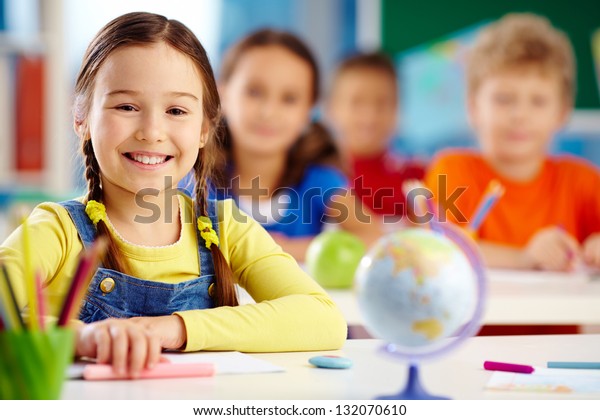 Portrait of an elementary school student with a\
toothy smile
