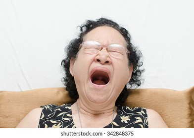 Portrait Of Emotion Asian Senior Woman With Yawn Expression