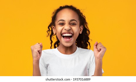 Portrait Of Emotional Black Girl Screaming With Raised Fists