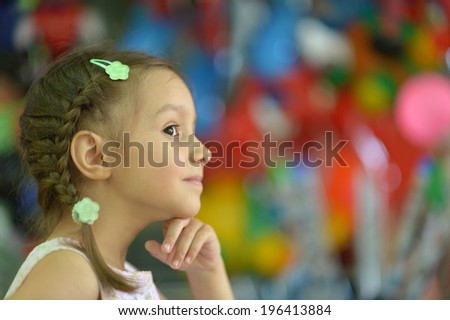 Funny child looking at the camera and painting