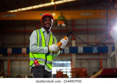 Portrait Engineer African American Worker Controls Heavy Machinery In A Factory Engineer Black Man Works With Machines. Looking At Camera