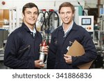 Portrait Of Engineer And Apprentice In Factory
