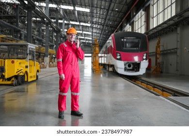Portrait of engineer and apprentice in workshop of railway engineering facility