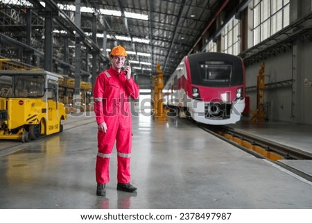 Portrait of engineer and apprentice in workshop of railway engineering facility