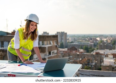 Portrait of engineer businesswoman at construction site. Female architect with blueprint. - Shutterstock ID 2232833925