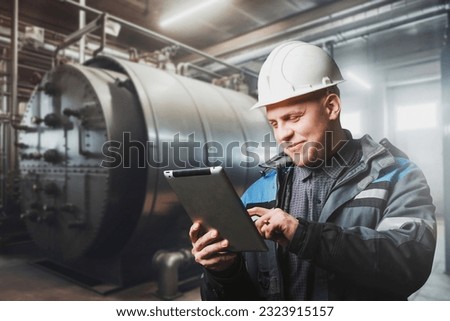 Portrait of the Engineer checking the reliability and serviceability of the boiler system