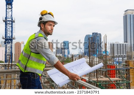 Portrait of an engineer designing a large project inspecting the job site to meet specifications.