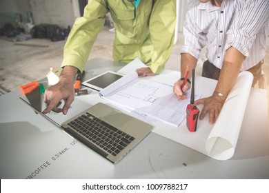 portrait engineer people working and discussing with blueprint and holding pencil on hand at construction site, using as background (concept of teamwork and partnership)
