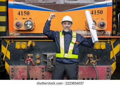 Portrait of Engineer in the process of inspecting train engines
