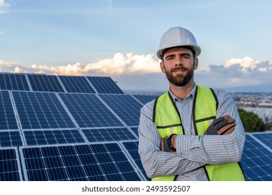 portrait of an engineer smiling with confidence in front of a solar panel power station, handsome male technician electrician looking at camera, photography with copy space for text - Powered by Shutterstock