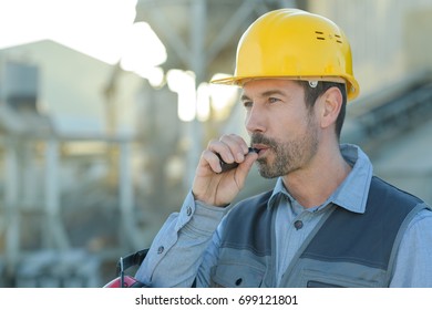 Portrait Of Engineer Smoking Electronic Cigarette Outdoors