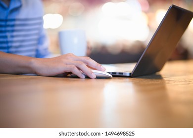 Portrait of engineer working at his laptop on the office.Background in cafe. - Shutterstock ID 1494698525