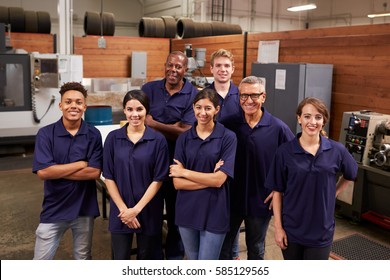 Portrait Of Engineers And Apprentices In Busy Factory