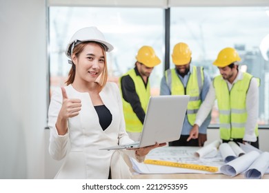 Portrait Of Engineers Facing The Camera As They Wrap Up A Group Discussion For An Architectural Project.