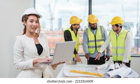 Portrait Of Engineers Facing The Camera As They Wrap Up A Group Discussion For An Architectural Project.