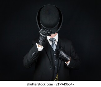 Portrait of English Gentleman in Dark Suit and Leather Gloves Tipping Bowler Hat in Greeting. Classic British Butler or Businessman. - Shutterstock ID 2199436547