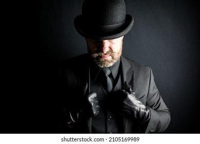 Portrait Of Englishman In Dark Suit And Bowler Hat With A Mean Scowl. Concept Of Gangster Or Mafia Hitman.