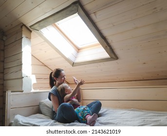 Portrait of enjoy happy family mother and little girl hugging, smiling, playing and having good time in a cozy room at home. - Shutterstock ID 2143621019