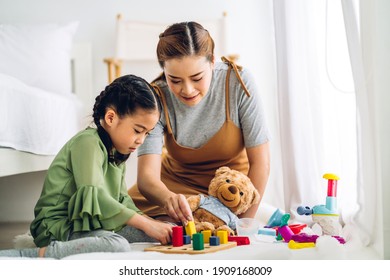 Portrait Of Enjoy Happy Love Asian Family Mother And Little Asian Girl Smiling Playing With Toy Build Wooden Blocks Board Game In Moments Good Time At Home