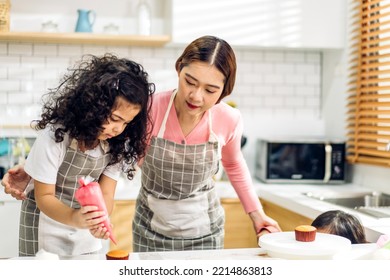 Portrait Of Enjoy Happy Love Asian Family Mother And Little Toddler Asian Girl Daughter Child Having Fun Cooking Together With Dough For Homemade Bake Cookie And Cake Ingredient On Table In Kitchen